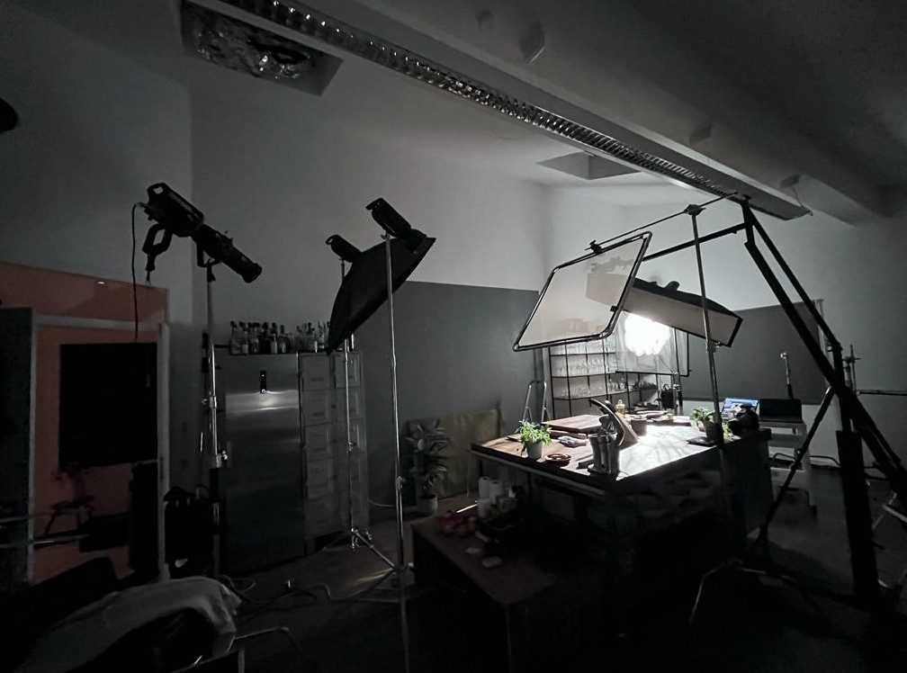 Abgedunkeltes Studio mit hell ausgeleuchtetem Foodset unter grossem Diffusor — Das Studiozwei, Werbefotograf München